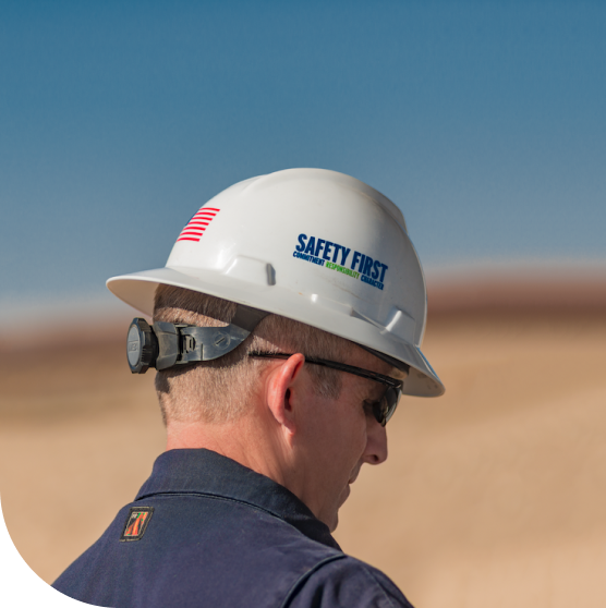 Employee wearing helmet looking down